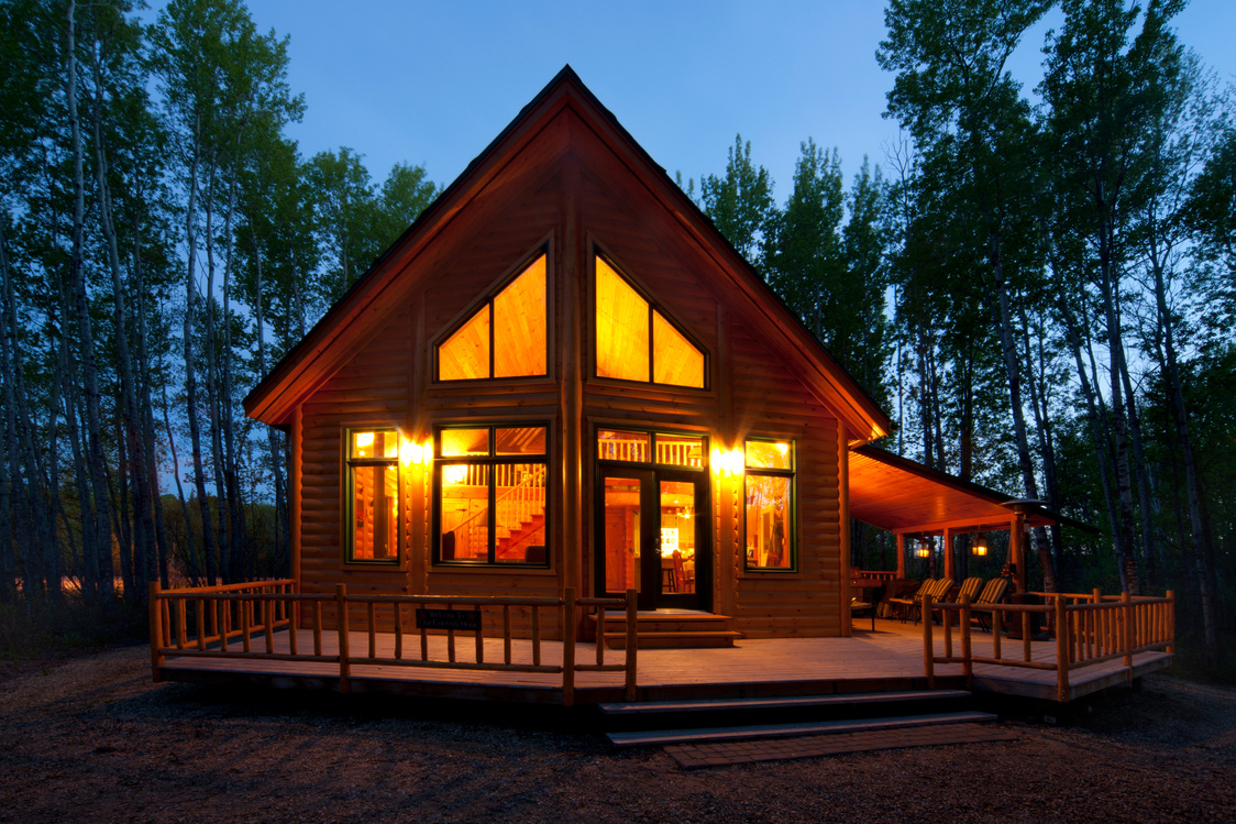 Cabin in woods at dusk